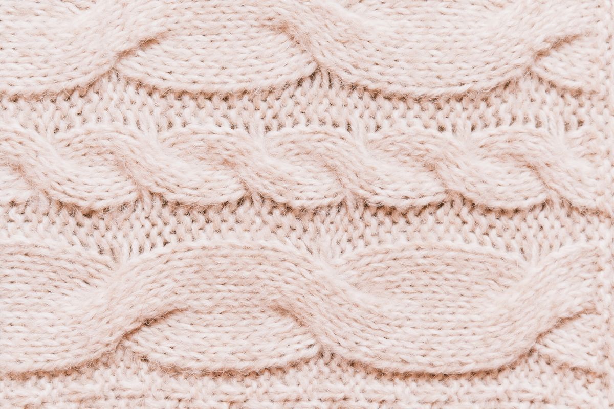 Pastel cable-knit fabric in close-up