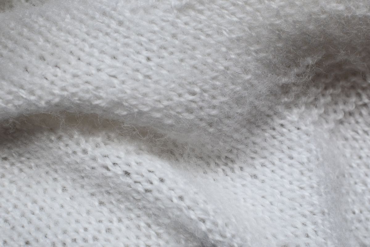 Fine white cashmere-style knit with a soft halo of fibers