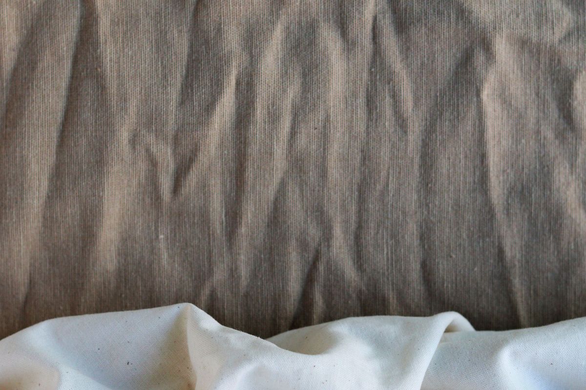 Close-up of natural undyed cotton cloth in soft folds